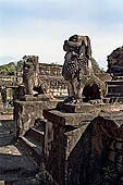 Bakong temple - guarding lions of the ancillary tower.